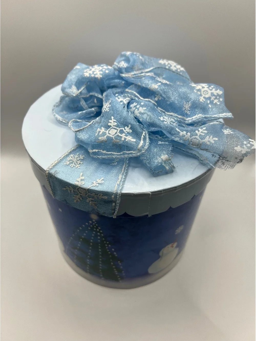 Blue Holiday Christmas cylinder round gift box with snowman and Christmas tree